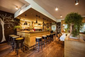 a restaurant with a bar with stools at La Pinte du Vieux Manoir in Murten