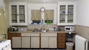 a kitchen with a sink and a clock on the wall at Non-Smokers Only Private Room 6 with Kitchen Best Price for 1 Long-Term Guest 