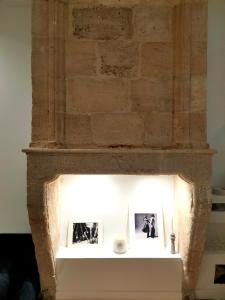 a brick fireplace with two photos on it at Modern Flat Historic Center in Bordeaux