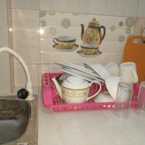a pink tray with dishes and a tea set on a counter at Star Home Stay Bentota in Bentota
