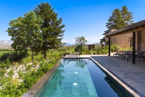 a swimming pool in the backyard of a house at Dimora Cottanera in Castiglione di Sicilia