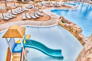 a swimming pool with a slide in a resort at ALEGRIA Cabo De Gata in Retamar