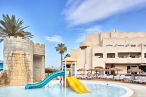 a pool with a slide in front of a building at ALEGRIA Cabo De Gata in Retamar