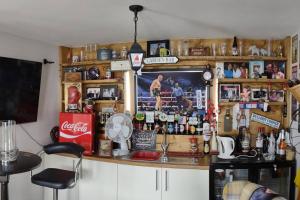 a bar with a lot ofcellaneous items on the wall at The Cubley Retreat in Sheffield