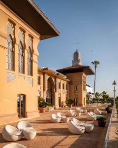 a building with white seats in front of a building at ALEGRIA Palacio Mojacar - Adults Only in Mojácar