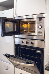 an oven with two microwaves on top of it at Castellana Norte Ml8 in Madrid