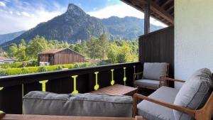 a balcony with two chairs and a view of a mountain at Servus O´gau Apartments in Oberammergau
