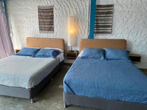 two beds sitting next to each other in a bedroom at Hotel Casa Lucca in Medellín