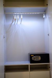 a room with a tv on a shelf with lights at Xanthippi Hotel in Souvala