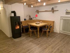 a kitchen with a table and a stove in a room at Ferienwohnung "Am Mittag" in Blaichach