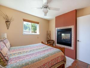a bedroom with a bed and a flat screen tv at Rio Vista Casita in Santa Fe