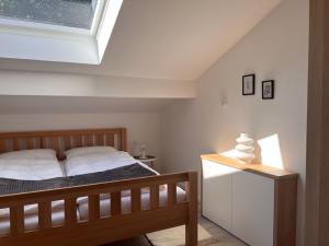 a bedroom with a bed and a skylight at Ferienwohnung Kohl - Dachlmoos in Bischofswiesen