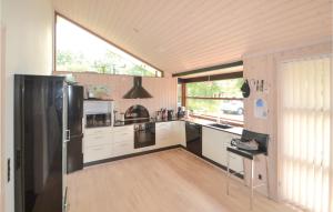 a kitchen with a black refrigerator and a window at Pet Friendly Home In Grenaa With Kitchen in Grenå