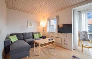 a living room with a couch and a table at Stunning Home In Juelsminde With House Sea View in Juelsminde