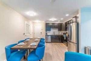 een keuken met een lange tafel en blauwe stoelen bij TVPM-4OO1#2O3BD VC apts in Orlando