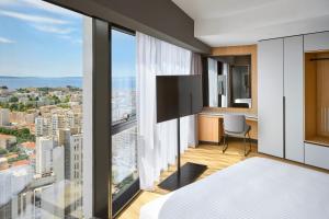 a bedroom with a view of a city at AC Hotel by Marriott Split in Split