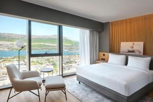 a bedroom with a large bed and a large window at AC Hotel by Marriott Split in Split