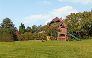 a playground in a field with a play structure at Pet Friendly Home In Wiselka With House A Panoramic View in Wisełka