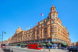 a large building with a red bus in front of it at Harrods 2 Bed Lux Flat w/patio in London
