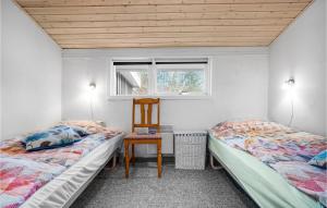 FjellerupにあるAwesome Home In Glesborg With 3 Bedrooms And Wifiのベッド2台、椅子、窓が備わる客室です。