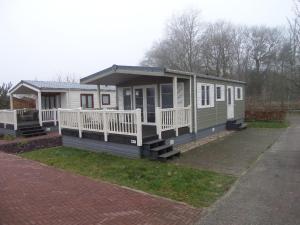 a tiny house on the side of a road at Vakantiepark Camping de Peelpoort in Heusden