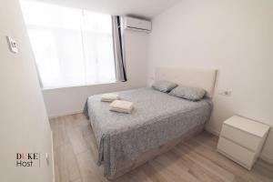 a small bedroom with a bed and a window at Castellana Norte Ml8-2 in Madrid