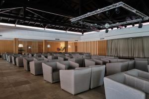 a room with rows of chairs and curtains at Prinsotel La Dorada & Spa in Playa de Muro