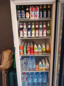 a refrigerator filled with lots of bottles of drinks at Rose city inn in Wadi Musa