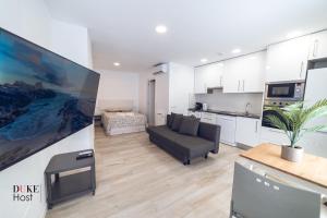 a living room with a couch and a kitchen at Castellana Norte Ml8-2 in Madrid