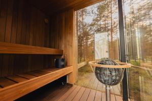 a sauna with a large window and a fan at ÖÖD Hötels Lohusalu LEIDA & ENNO in Laulasmaa +35 photos