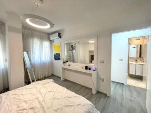 a bedroom with a large bed and a bathroom at Durres Currila RELAX Beach Lifestyle in Durrës