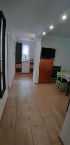 a living room with a large tile floor and a kitchen at Apartamenty u Rudej in Olszanica