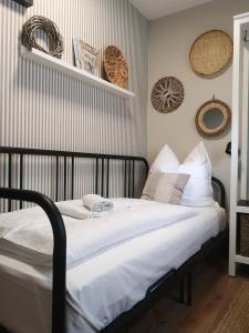 a bed with white sheets and pillows in a room at Pension Trent in Trent