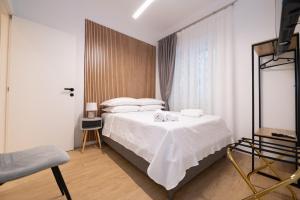 a bedroom with a white bed and a window at Domus Vatican Holiday in Rome