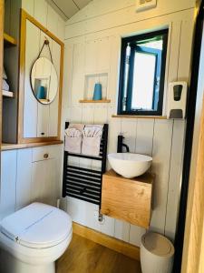 a small bathroom with a toilet and a sink at Cocklebury Farm in Pewsey +138 photos