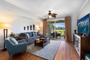 a living room with a couch and a tv at Waikoloa Beach Villas L3 in Waikoloa