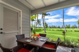 a table and chairs on a patio with a view of a yard at Waikoloa Beach Villas L3 in Waikoloa +42 photos
