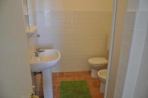 a bathroom with a sink and a toilet at Rossola House in Bonassola