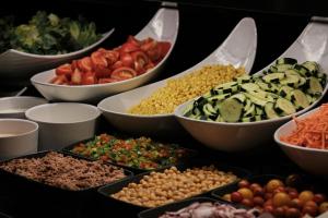 a table with bowls of different types of food at Prinsotel La Dorada & Spa in Playa de Muro