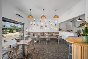a restaurant with tables and chairs and a couch at EGEDEN HOTEL in Datca
