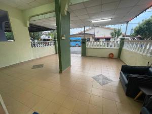 an empty room with a couch and a porch at Redzuan Homestay (Muslim Friendly) in Muar