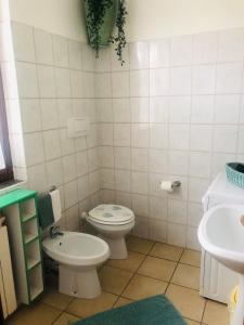 a small bathroom with a toilet and a sink at Casa Nonna Elide 2 in Besozzo +25 photos