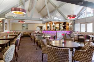 a restaurant with tables and chairs and a bar at Cromer Country Club in Cromer