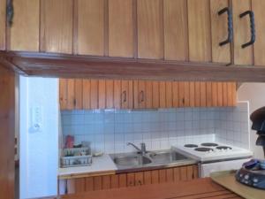 a kitchen with a sink and a stove at Appartement Méribel, 3 pièces, 6 personnes - FR-1-411-661 in Les Allues