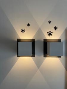 a room with two mirrors and snowflakes on the wall at Hotel Rech-Hof Sayonara in Folgaria