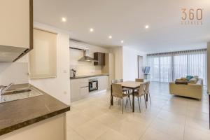 a kitchen and dining room with a table and chairs at Wonderful marina 3BR home, with LUX interior w/AC by 360 Estates in Tal-Pietà +35 photos