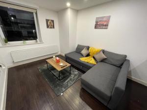 a living room with a couch and a table at Amazing 1 Bedroom Flat in Essex TH104 in Basildon