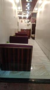 a row of benches in a waiting room at Hotel Host near Taj in Agra