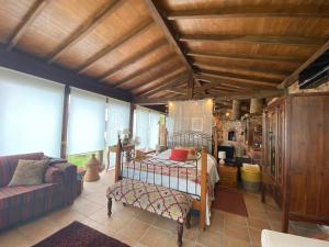 a bedroom with a bed and a couch at The Old Watermill Retreat - O Retiro da Azenha Velha in Vila Nova de Poiares
