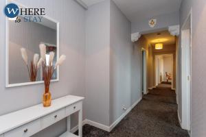 a hallway of a home with a mirror at Stunning 3 bedroom apartment Edinburgh in Edinburgh